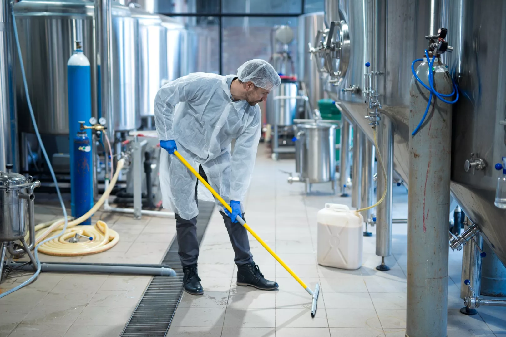 professional-industrial-cleaner-protective-uniform-cleaning-floor-food-processing-plant_08-07-2023